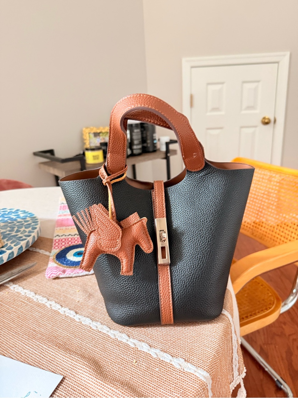 Mini Black Pebbled Leather Bucket Bag with Brown Trim and Horse Charm